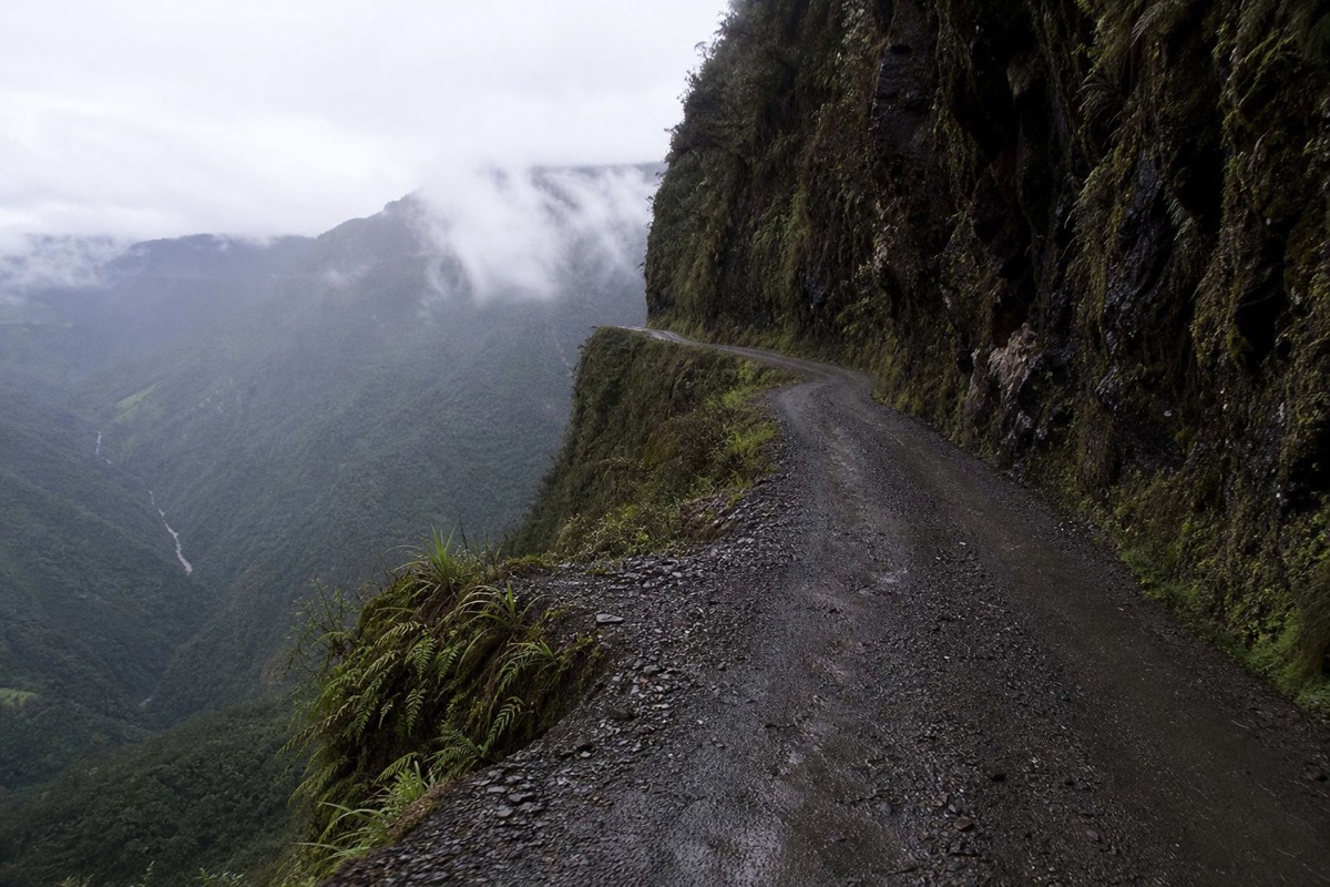 A narrow cliff section of the Death Road Bolivia carved into a sheer mountainside