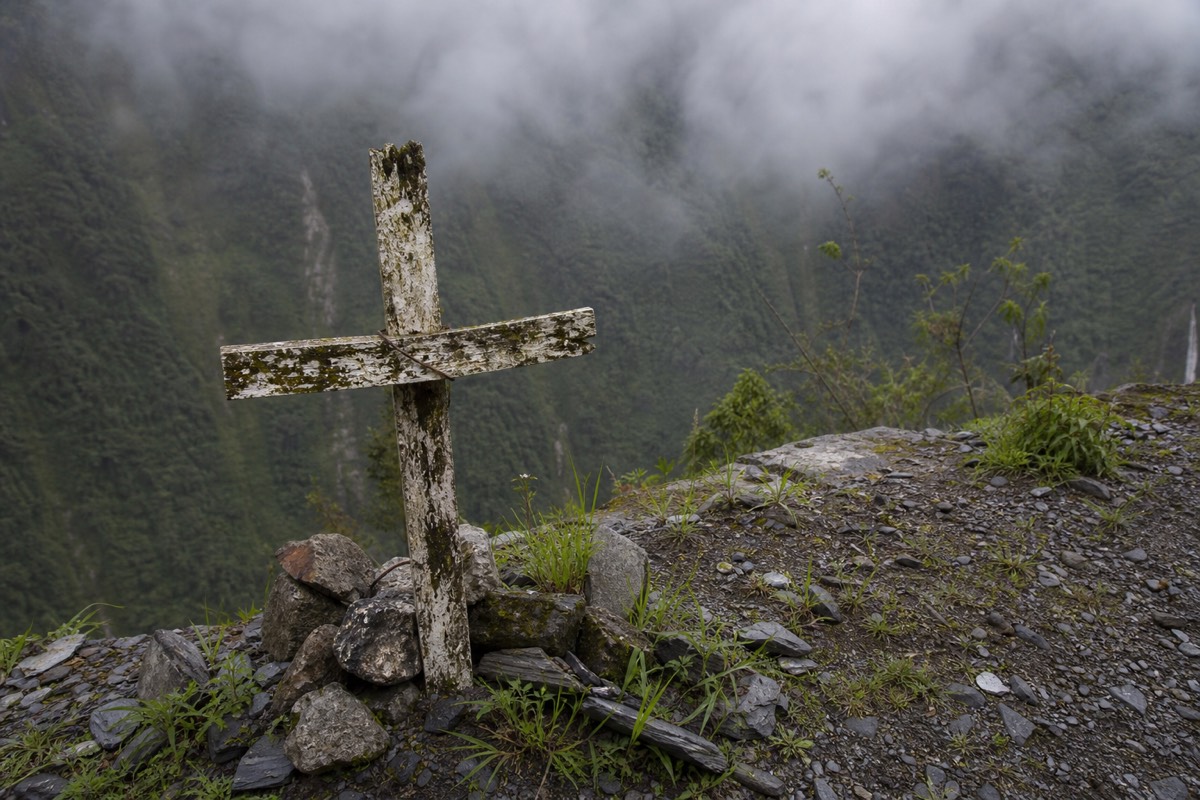 A roadside memorial cross marking deaths on the Death Road Bolivia